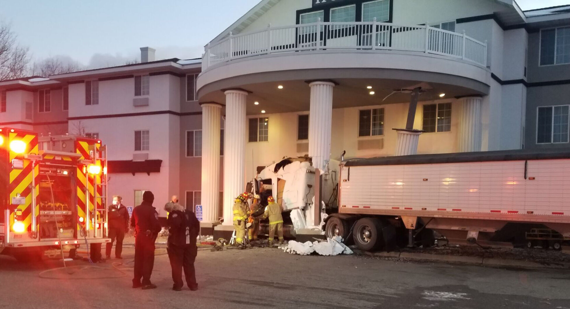 Semi crashes into hotel